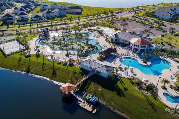 Aerial view of The Hideaway Club at Storey Lake Resort featuring a lazy river, swimming pools, and a dock