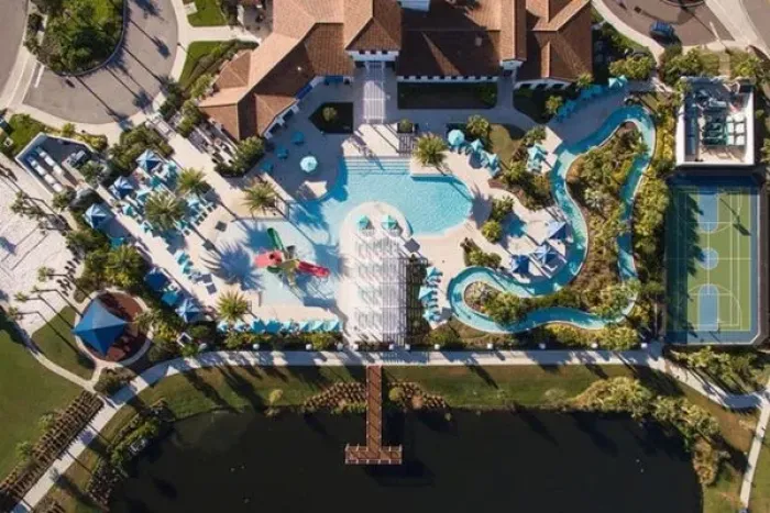 Aerial view of the resort pool complex, lazy river, and sports courts at Windsor at Westside