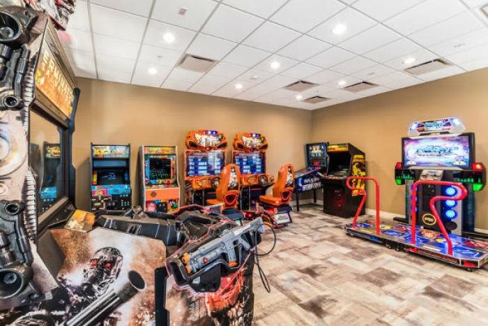 Arcade game room with racing and shooting games at Windsor at Westside