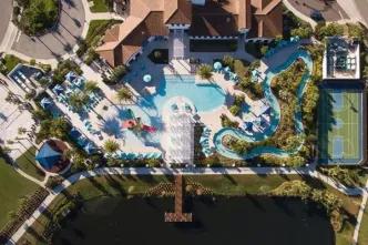 Aerial view of the resort pool complex, lazy river, and sports courts at Windsor at Westside
