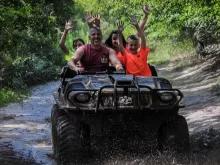 Adults and children having fun riding The Mucky Duck