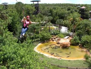 woman riding the Screamin’ Gator Zip Line at Gatorland