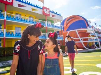A woman and girl walking in front of a hotel designed to look like an American football pitch