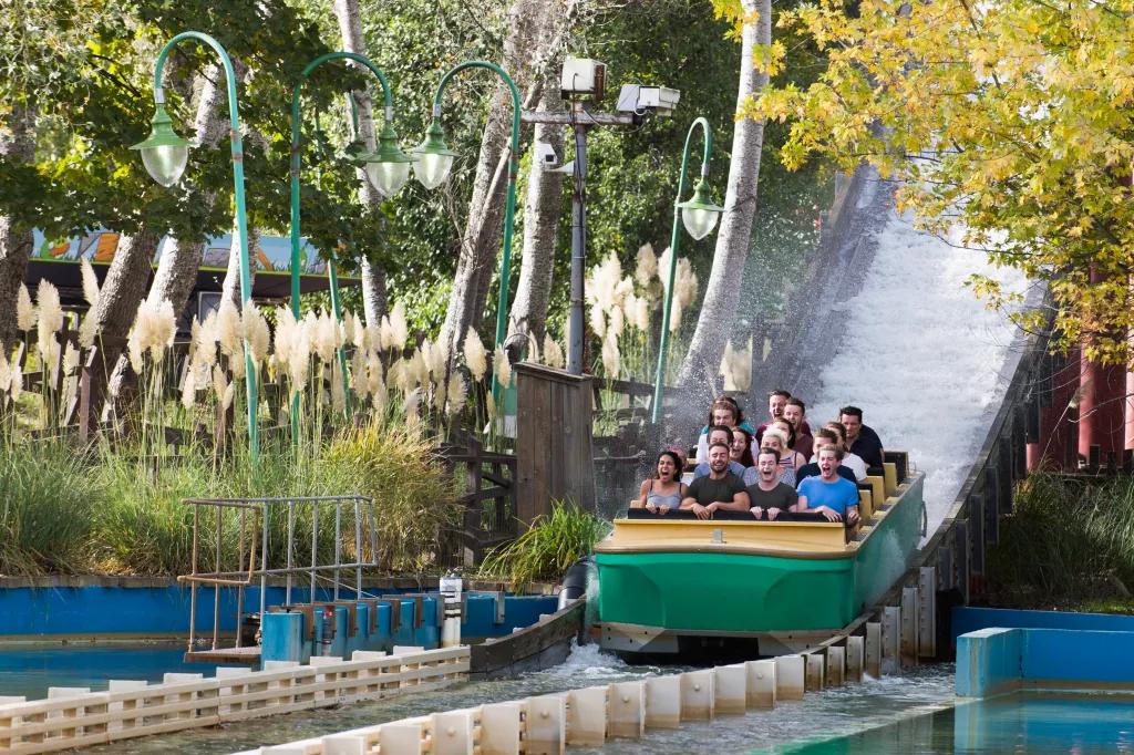 Guests soaked with water at the bottom of the drop on the Tidal Wave ride