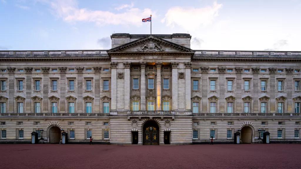 The front of Buckingham Palace with the Union Jack flying 