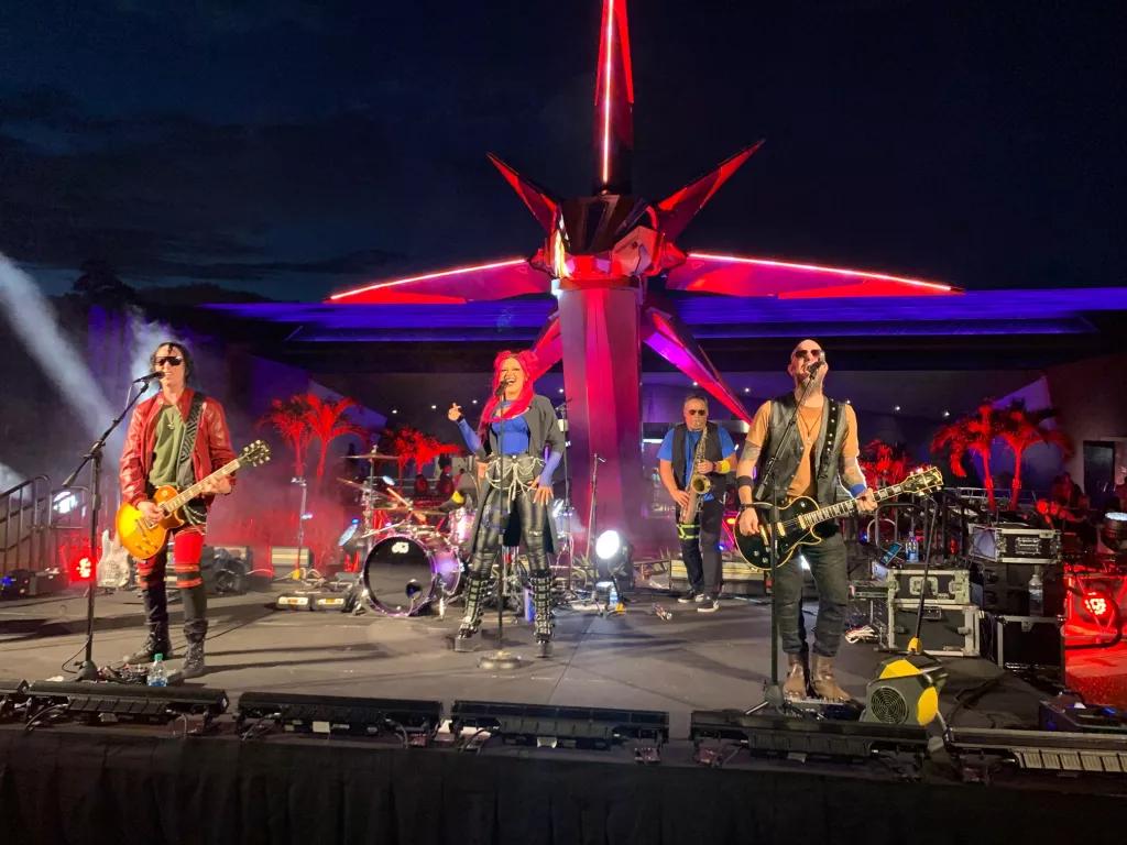 A band performing in front of Guardians of the Galaxy: Cosmic Rewind at night