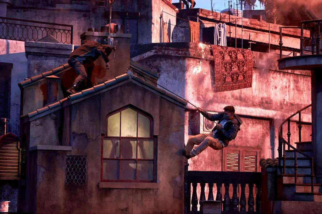 Stunt actors climbing down from a rooftop in the Bourne Stuntacular