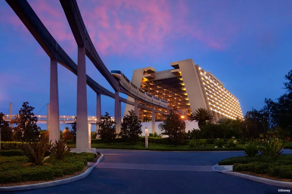 The monorail leaving the Contemporary Resort while the sun is setting