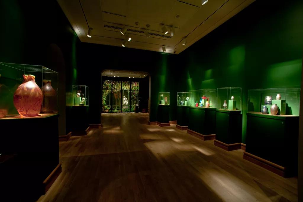 A museum with glass cases full of vases and pots