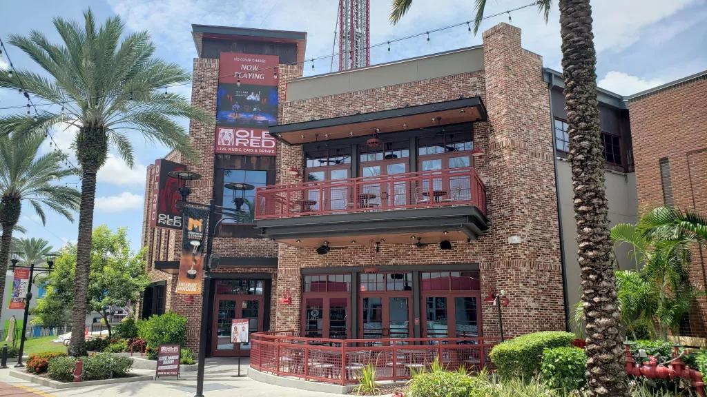 The exterior of Ole Red restaurant, a red brick building with red metal accents