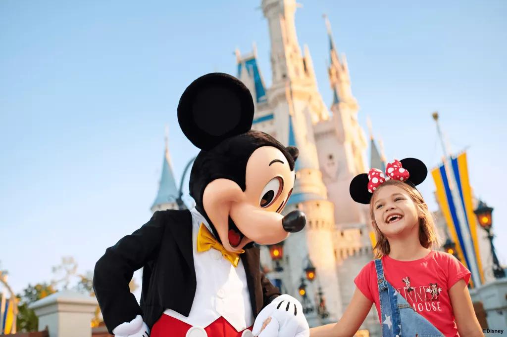 Mickey Mouse meeting a girl in front of Cinderella Castle in Magic Kingdom