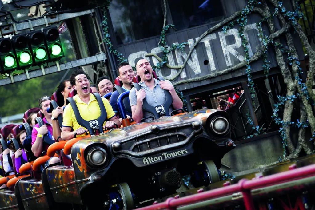 Guests screaming while riding a roller coaster 