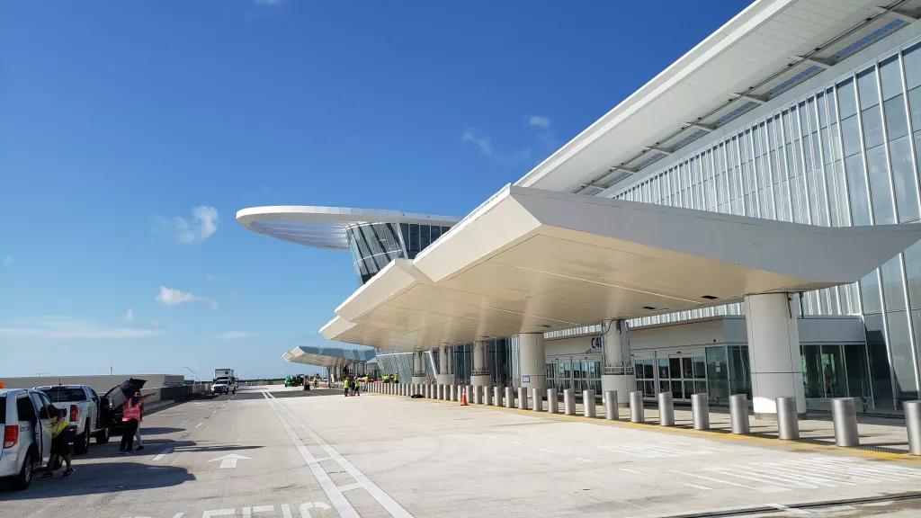 The outside of Terminal C at MCO with a road in front for taxis and drop off