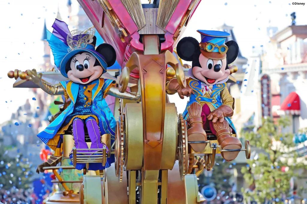 Mickey and Minnie in steampunk outfits sat on a parade float
