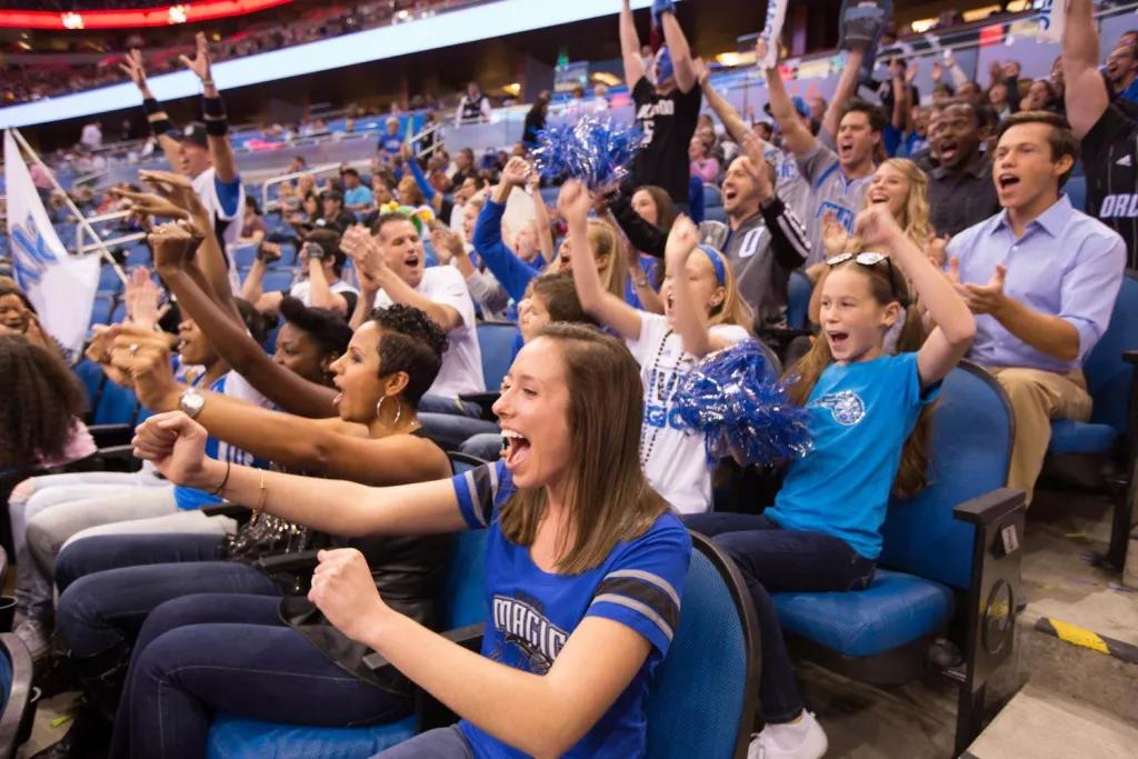 Orlando Magic fans in their seats cheering for the players