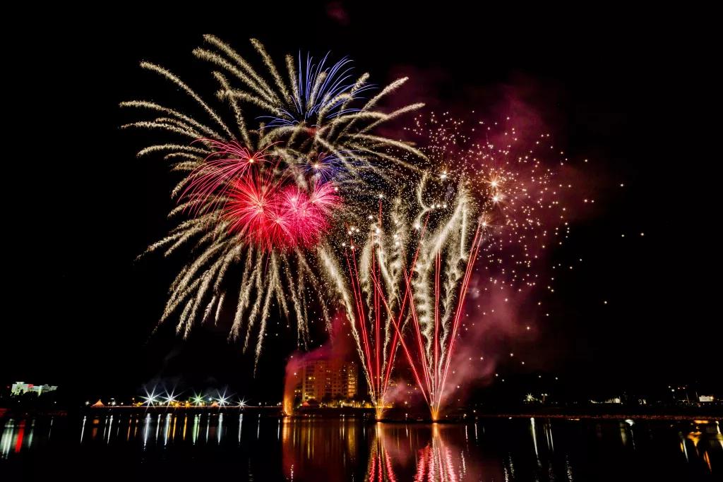 4th of July fireworks being set off above a large lake