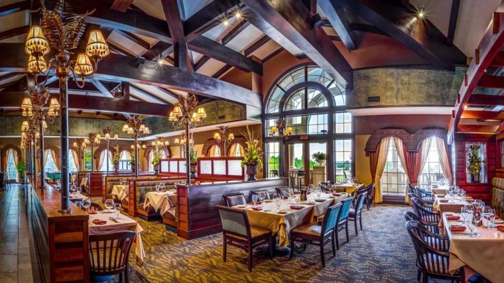 The dining room of A Land Remembered with tables and booths surrounded by wooden decor