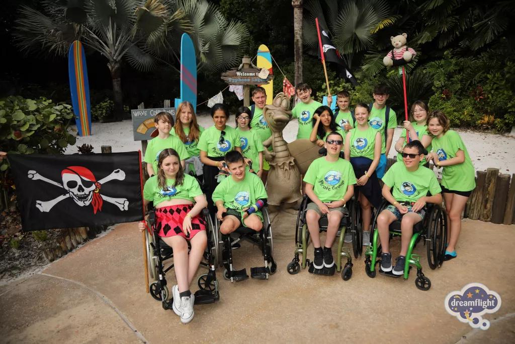 A group of children, some in wheelchairs, wearing bright green tshirts at Typhoon Lagoon 
