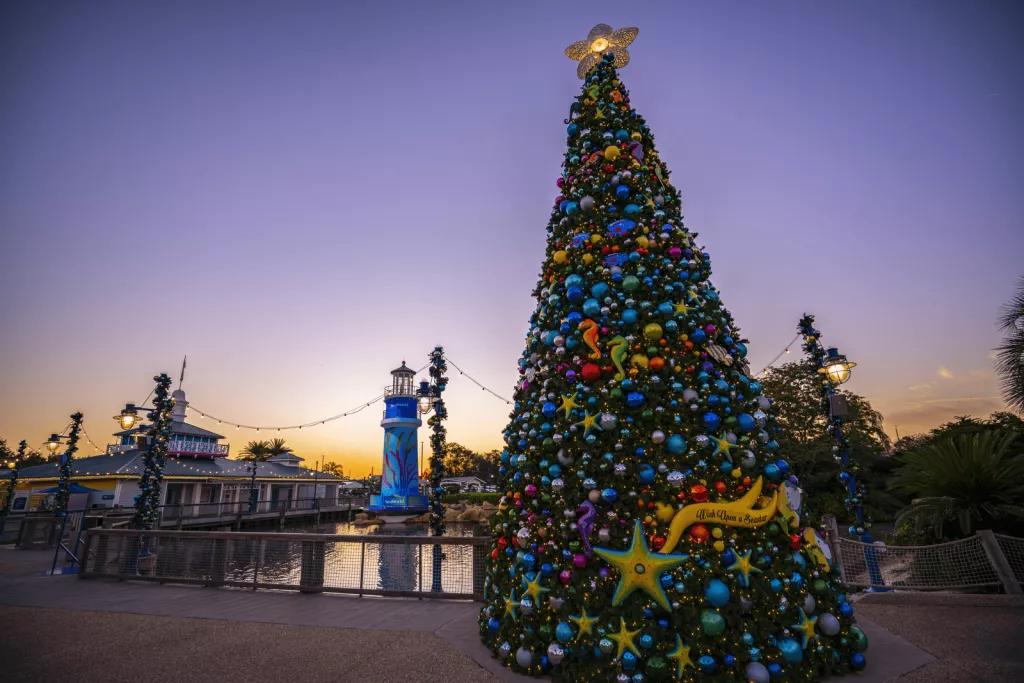 A decorated Christmas tree in SeaWorld while the sun is setting
