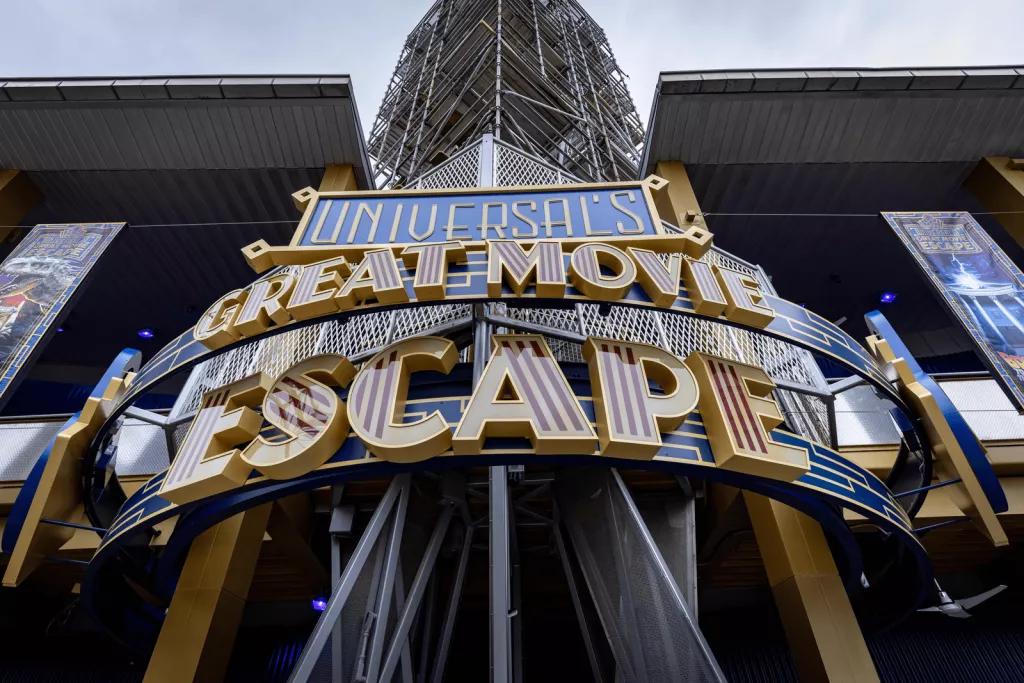 An art deco style sign on the outside of a building, which says Universal's Great Movie Escape