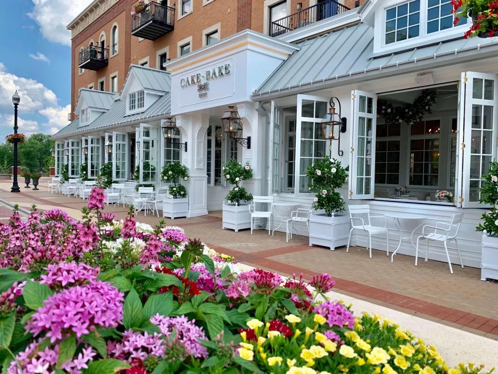 The exterior of the Cake Bake Shop in Indiana, with large open windows and outdoor seating
