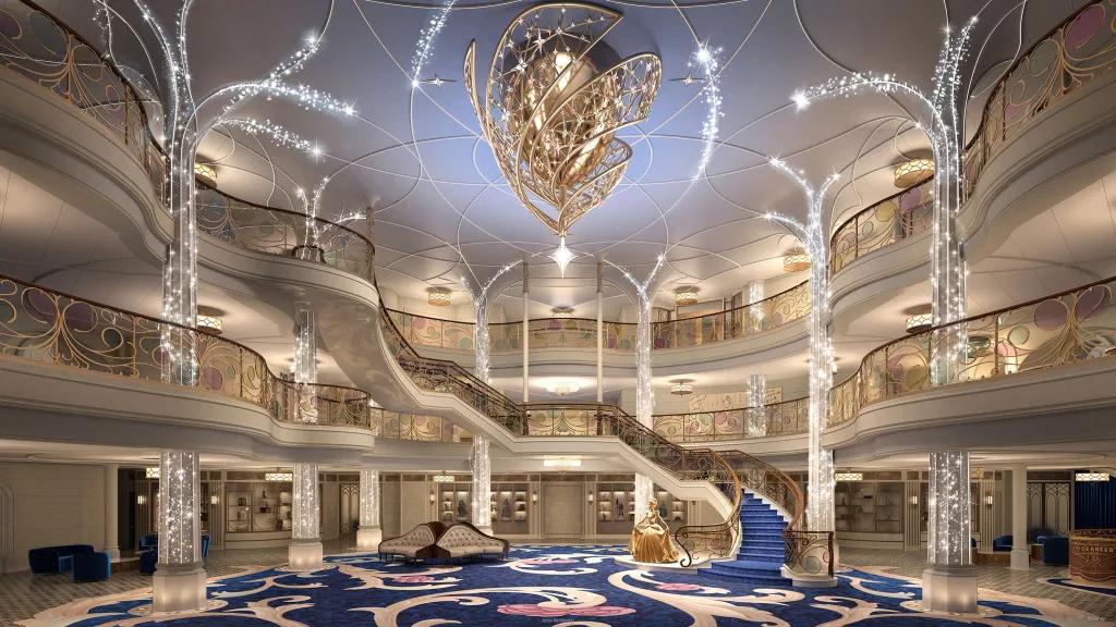 Concept art of the entrance hall on the Disney Wish, with a large grand staircase in the centre and sparkling tree-like pillars at the sides