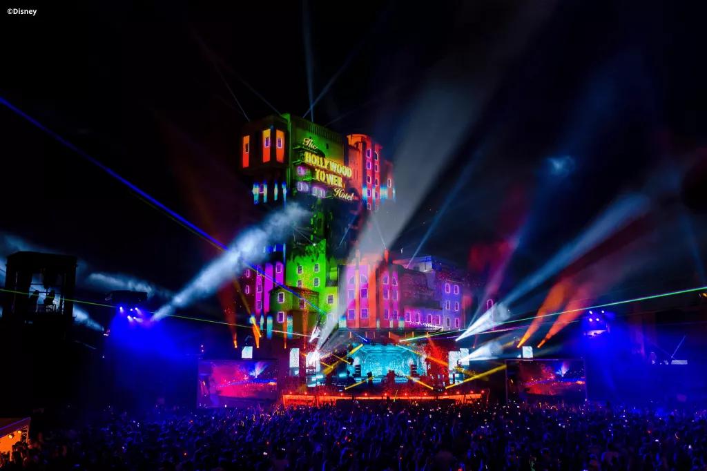 Tower of Terror at night lit up with rainbow colours and spotlights