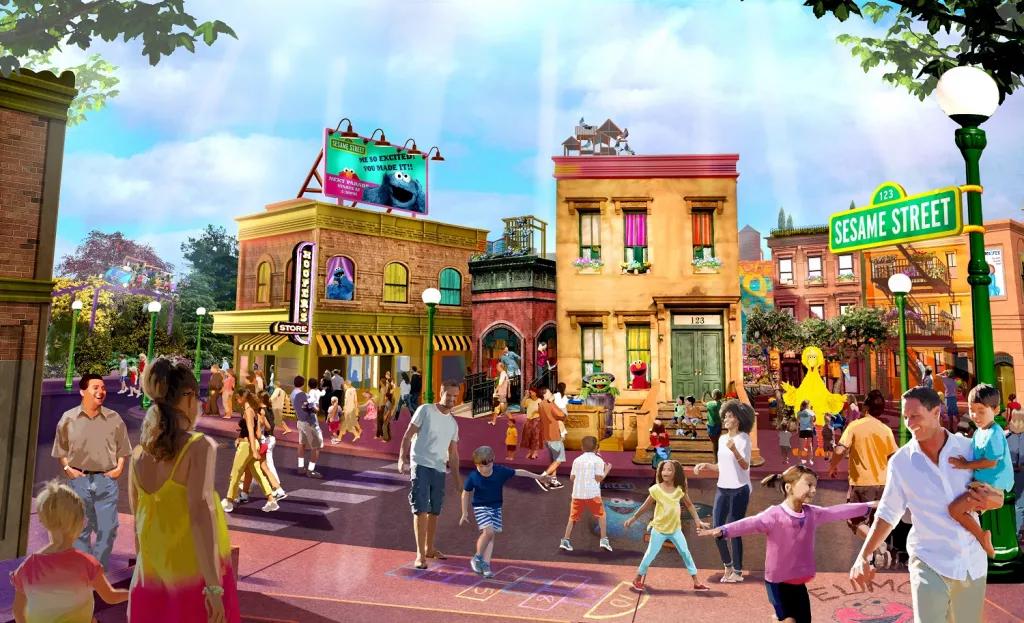 Concept art of Sesame Street Land with lots of families walking through a cartoon style New York street