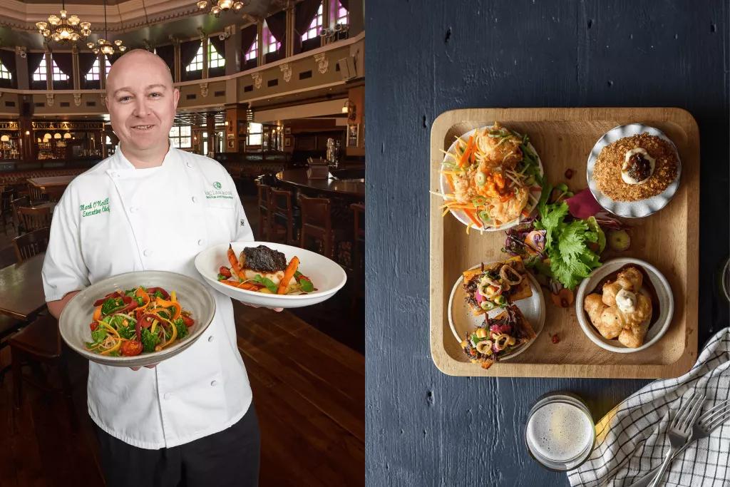 Chef Mark O'Neill holding two dishes and a 'Board of Beauty' with multiple appetisers on a tray