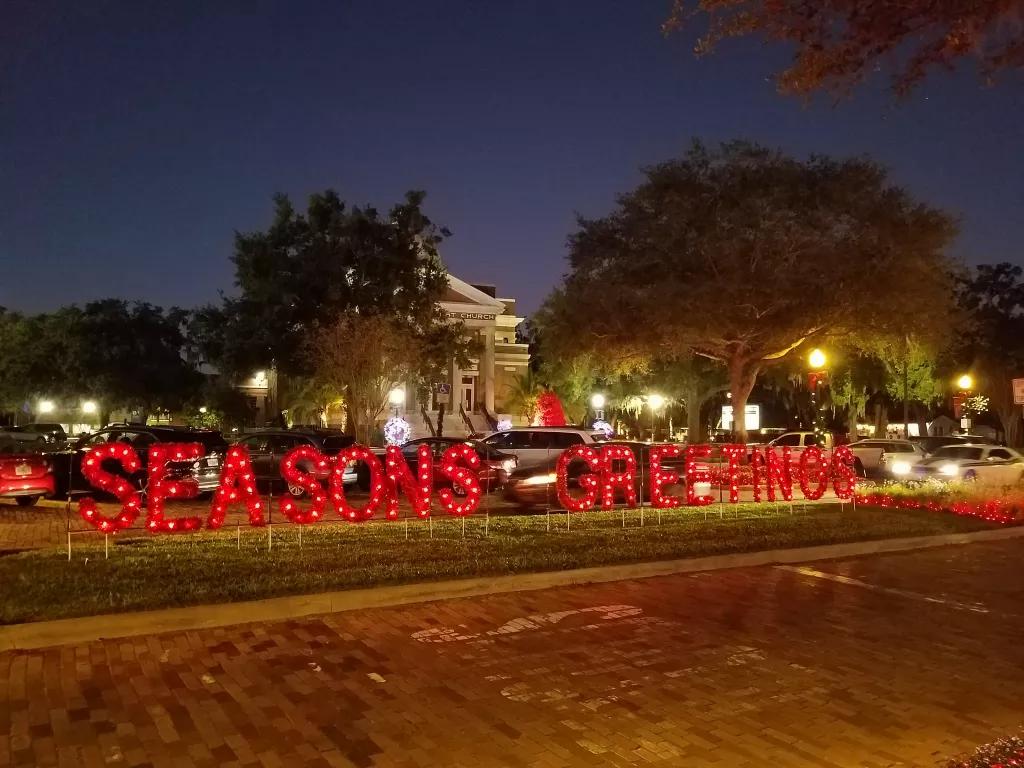 Large illuminated letters spelling out "Seasons Greetings"
