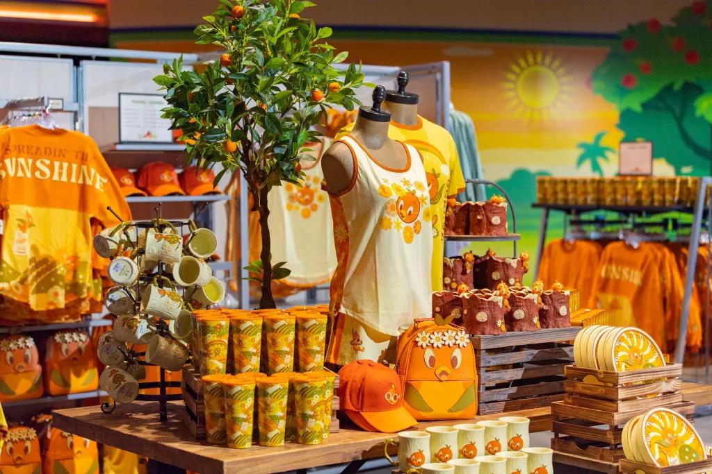 A stand of Orange Bird themed merchandise, including backpacks, clothing and mugs