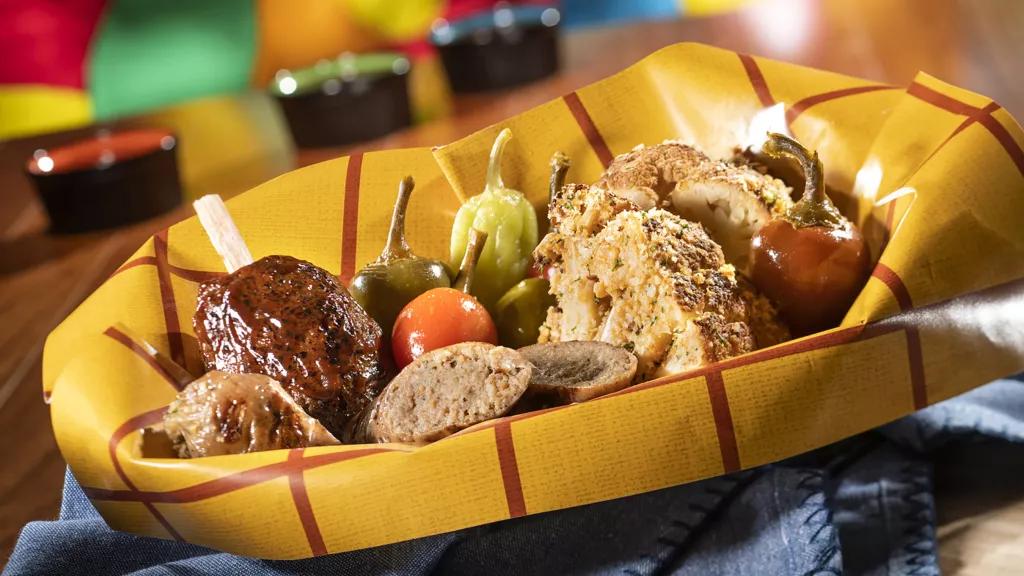A basket of plant-based food including 'sausage', 'pork chop' and roasted cauliflower