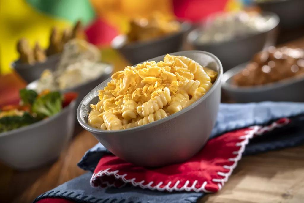 A metal bowl full of mac and cheese
