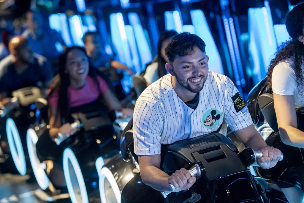 Guests sat on the TRON ride vehicles, as if they are sat on motorbikes