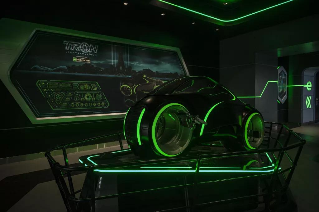 An example of a Tron ride vehicle, which looks like a motorbike lit up with green accents 