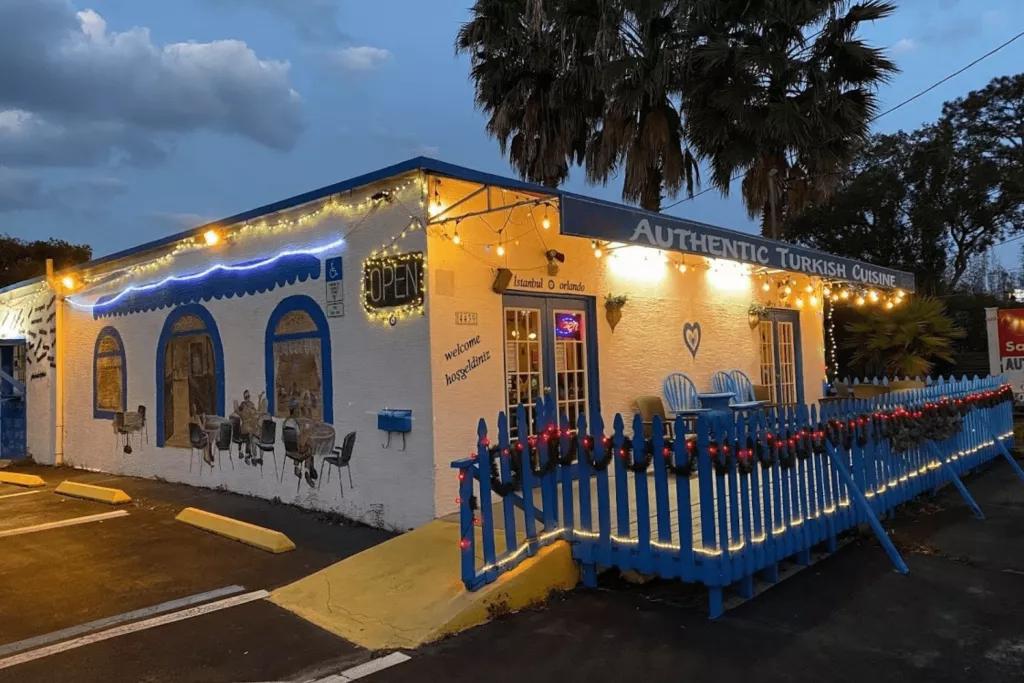 The exterior of a Turkish style restaurant with white walls and blue accents
