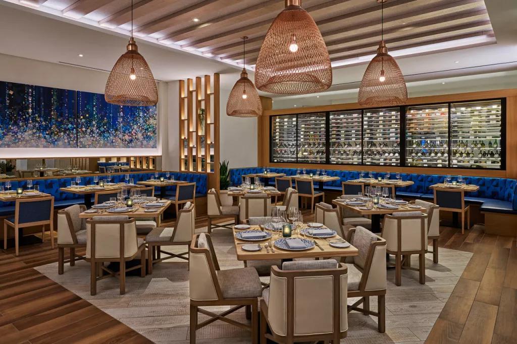 A restaurant dining room filled with tables and chairs set ready for customers to dine
