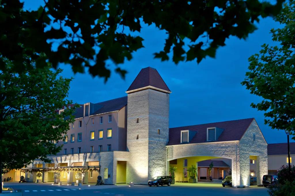 Explorers Hotel Marne-la-Vallée front exterior at night