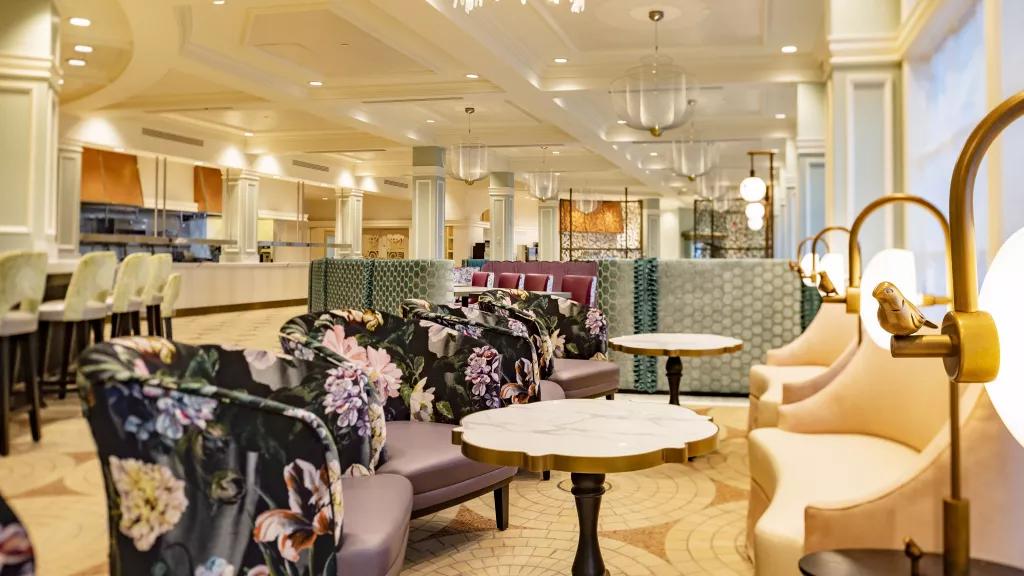 A restaurant lounge full of upholstered floral armchairs