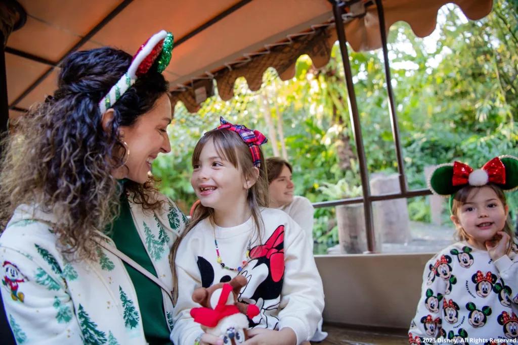 A family wearing Christmas outfits on a Jungle Cruise boat