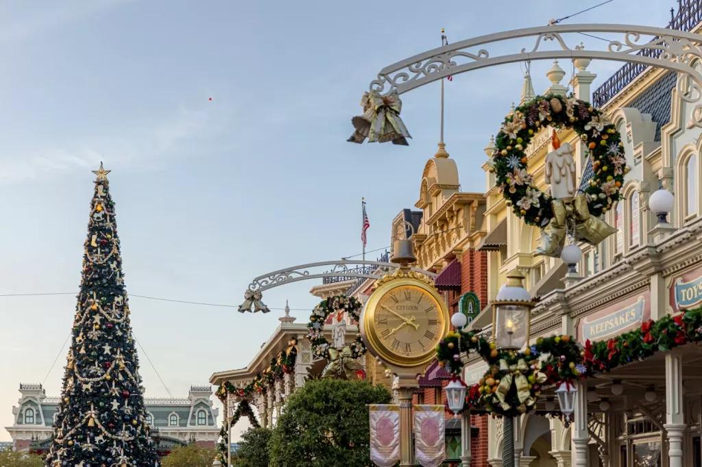 Main Street decorated with wreathes and ribbons leading to a giant Christmas tree