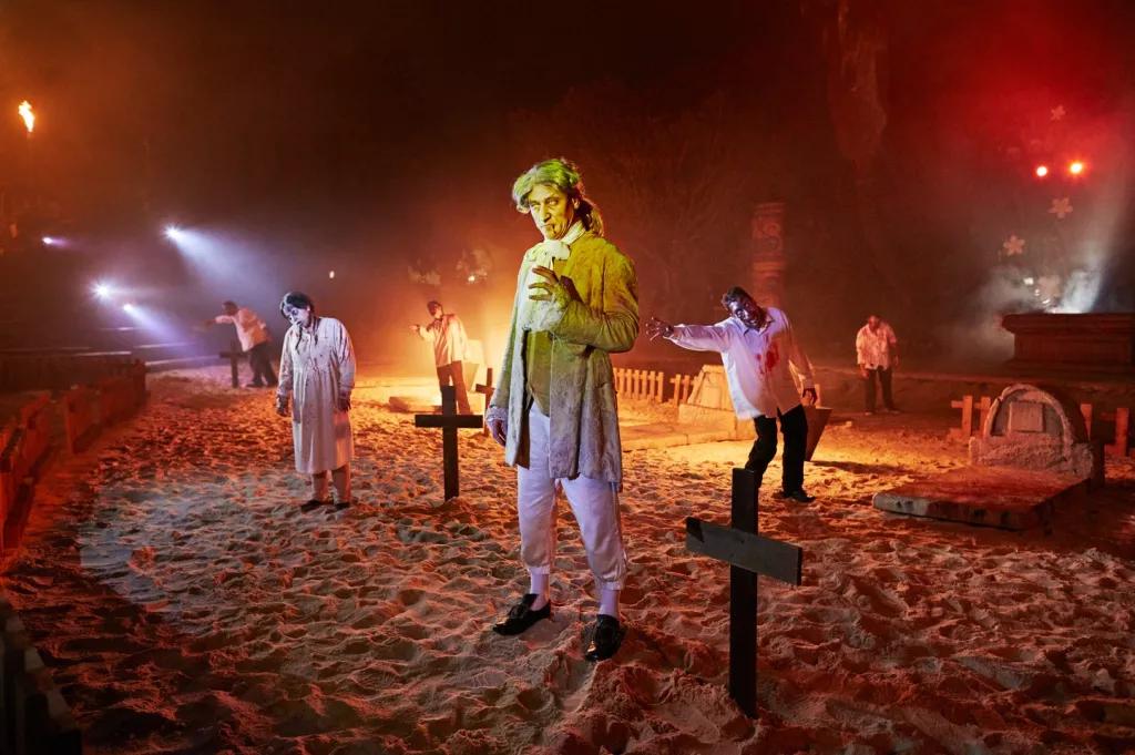 Zombie pirates standing on a beach covered in grave stones and crosses