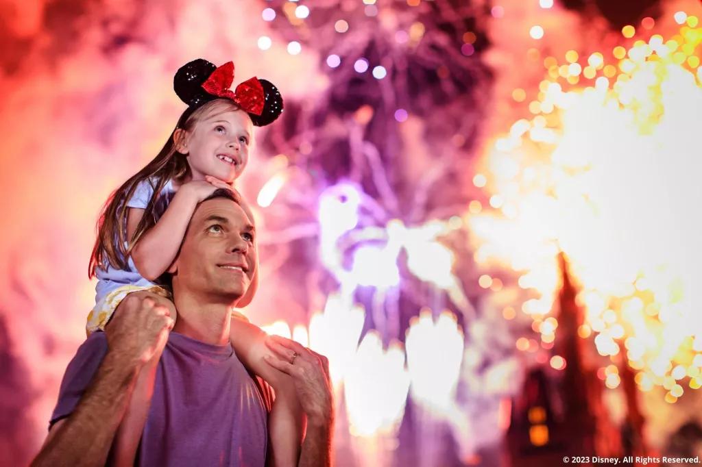 Familie vor dem Cinderella Schloss im Magic Kingdom Park schaut das Feuerwerk an