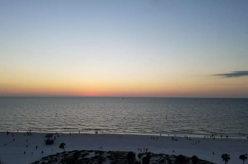 Looking out to the water of Clearwater Beach as the sun sets on the horizon