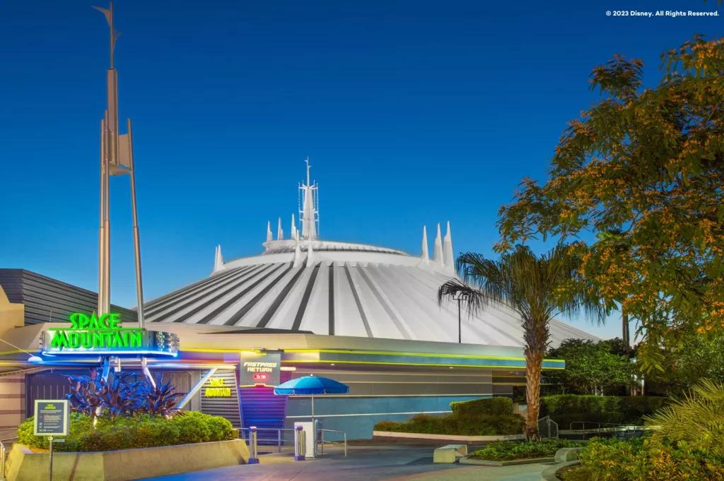A futuristic white dome behind a neon sign reading Space Mountain