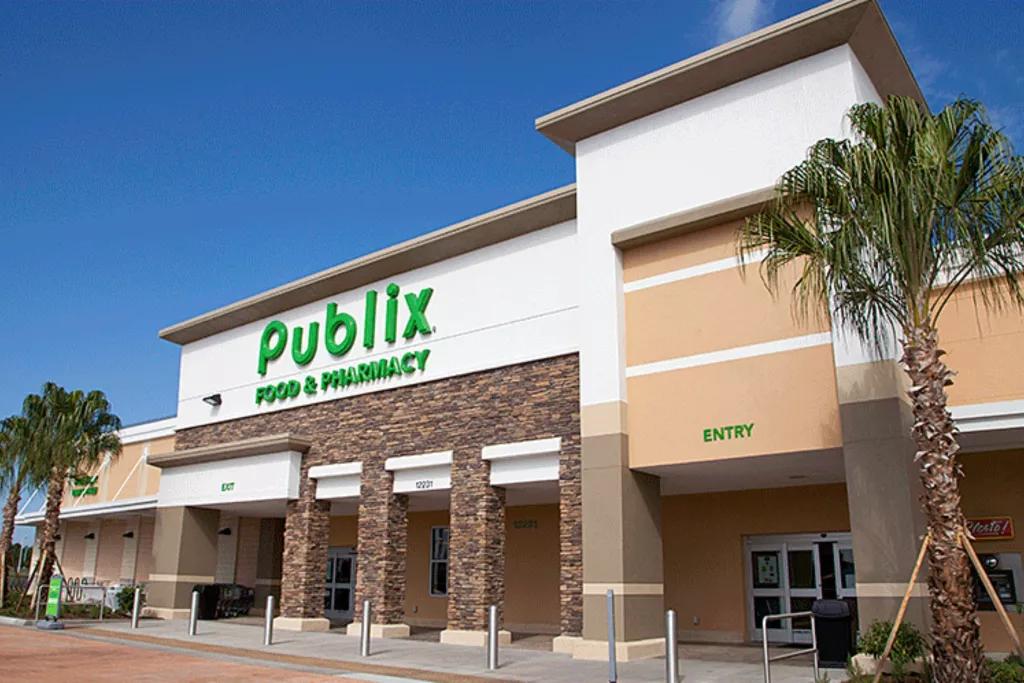The exterior of a Publix supermarket with palm trees in front and a blue sky behind