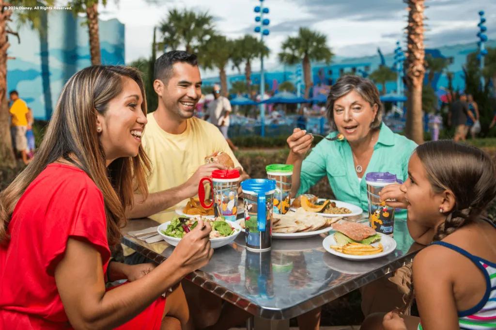A family eating salads and burgers sat at an outdoor table