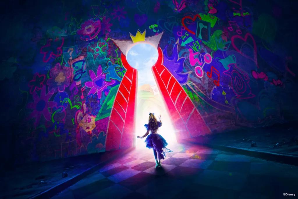 Alice in Wonderland walking through a large keyhole designed to look like the Queen of Hearts