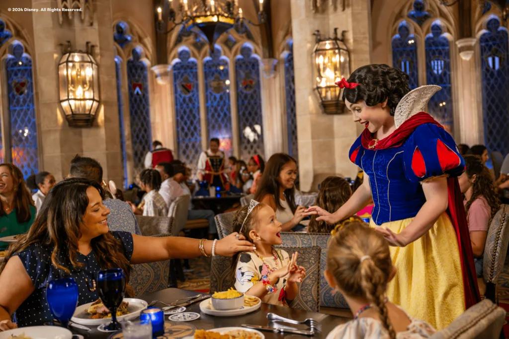 Snow White meeting a family sitting at a table eating dinner