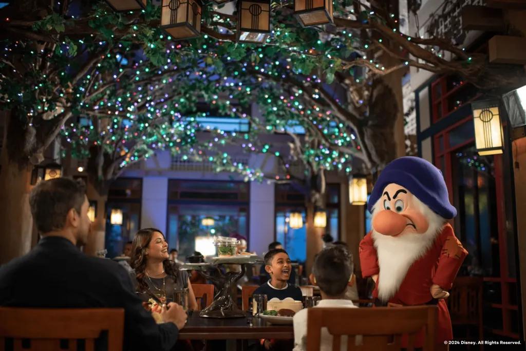 Grumpy meeting a family sitting at a table eating dinner
